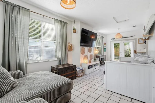 a bedroom with furniture and a flat screen tv