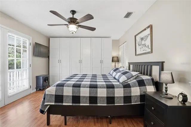 a bedroom with a bed and wooden floor