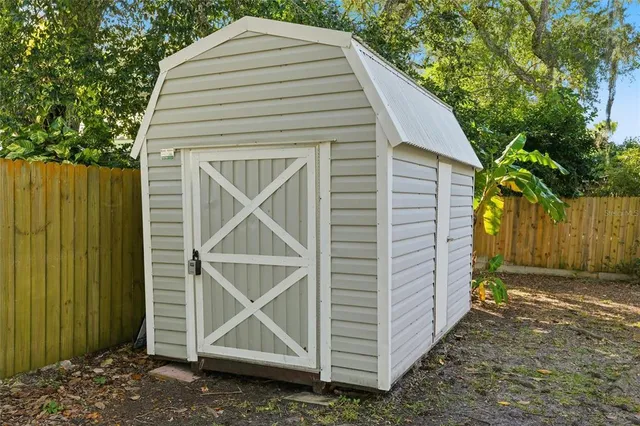 a view of small house with backyard space