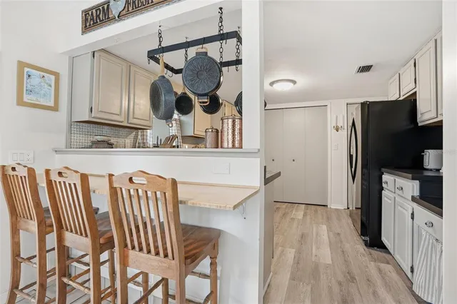 a kitchen with stainless steel appliances granite countertop a sink and a refrigerator