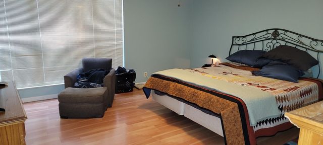 a bedroom with bed and a window