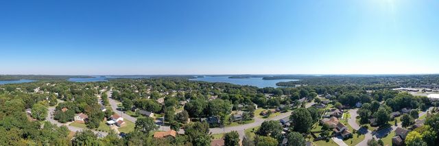 an aerial view of a houses with a yard