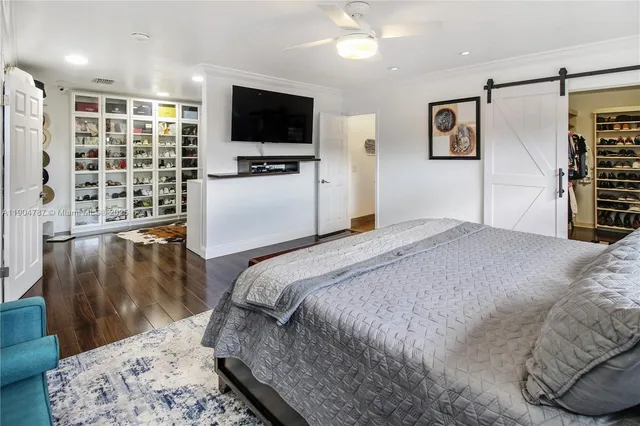 a large dining hall with stainless steel appliances granite countertop a stove top oven a dining table and chairs with wooden floor