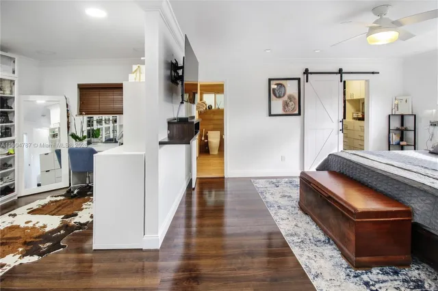 a dining room with wooden floor a chandelier a wooden table and chairs