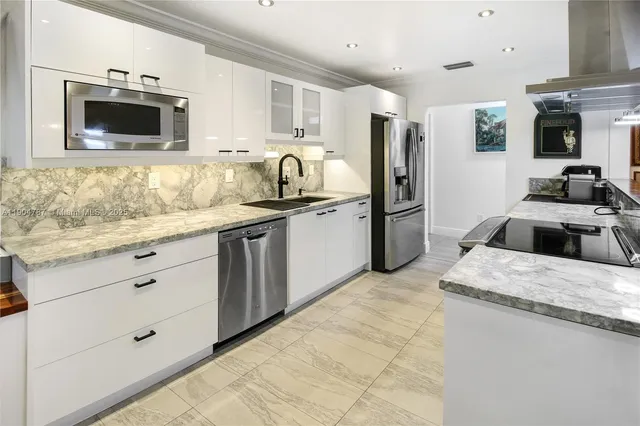 a view of a swimming pool with a large tree in front of it