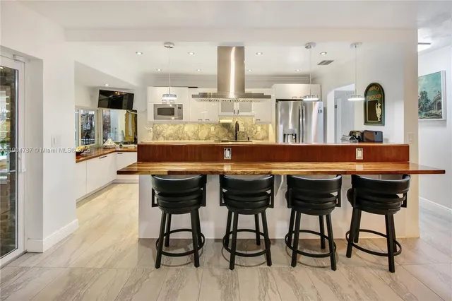 a view of a backyard with plants and a lake view