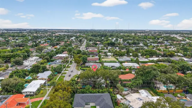 an aerial view of a house with garden space and street view