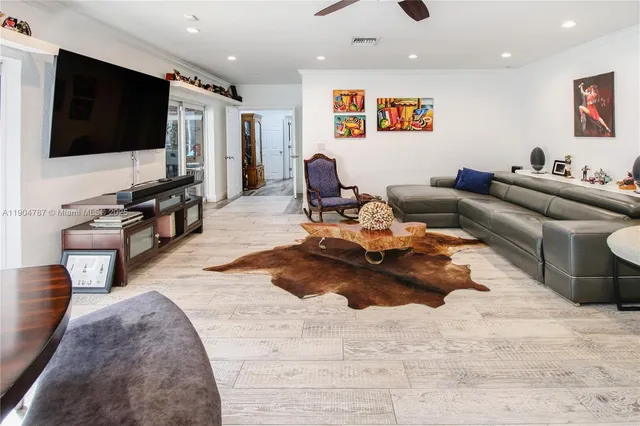a living room filled with furniture and a wooden floor