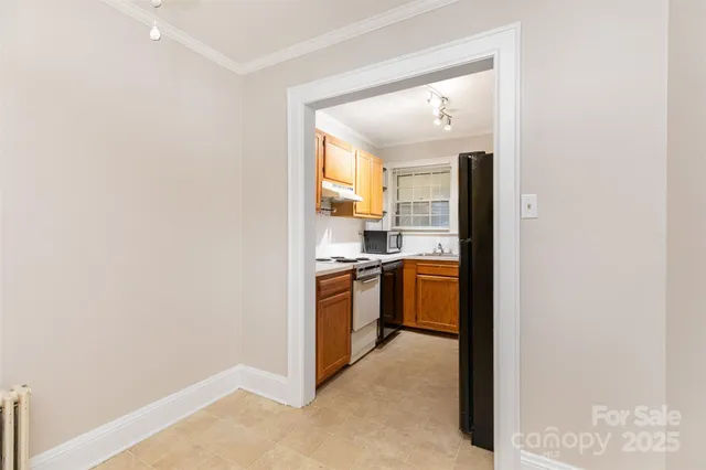 a kitchen with a refrigerator and a stove