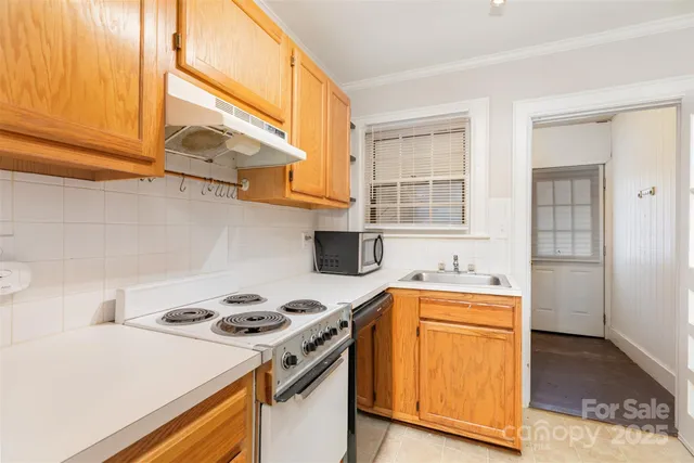 a kitchen with a stove and a sink
