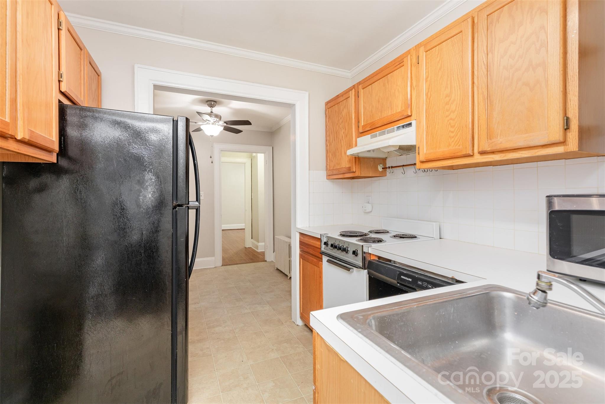 1412 Kenilworth Avenue Charlotte, NC 28203 - Photo 15 of 25 a kitchen with stainless steel appliances granite countertop a refrigerator a sink and a stove