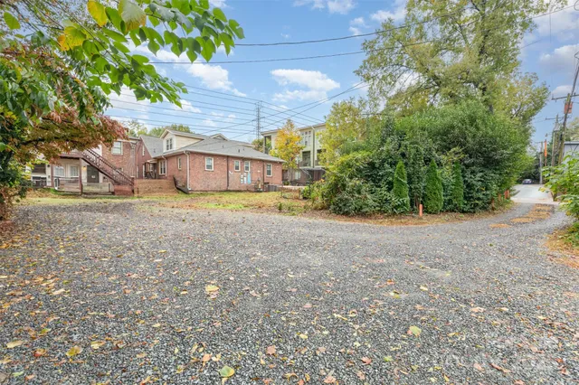 a view of a house with a yard and tree