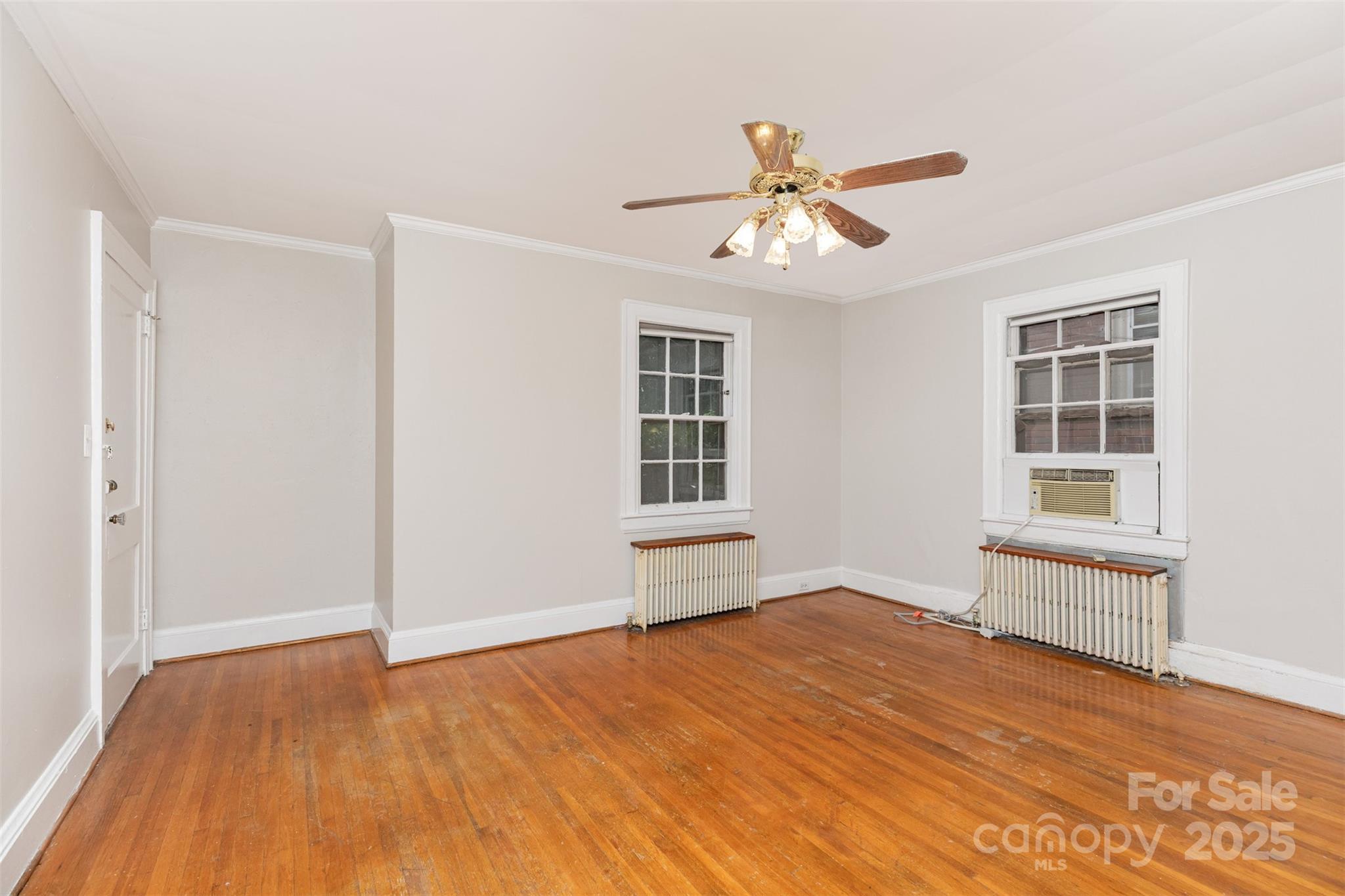 1412 Kenilworth Avenue Charlotte, NC 28203 - Photo 6 of 25 a view of empty room with wooden floor and fan