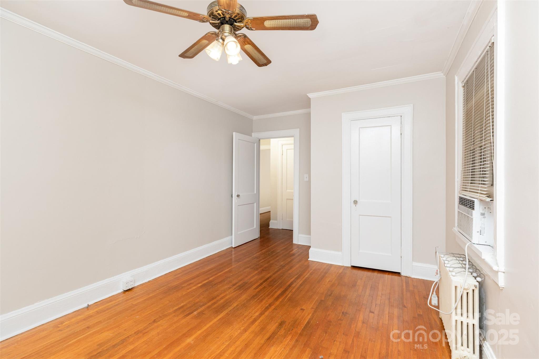 1412 Kenilworth Avenue Charlotte, NC 28203 - Photo 10 of 25 an empty room with wooden floor and windows