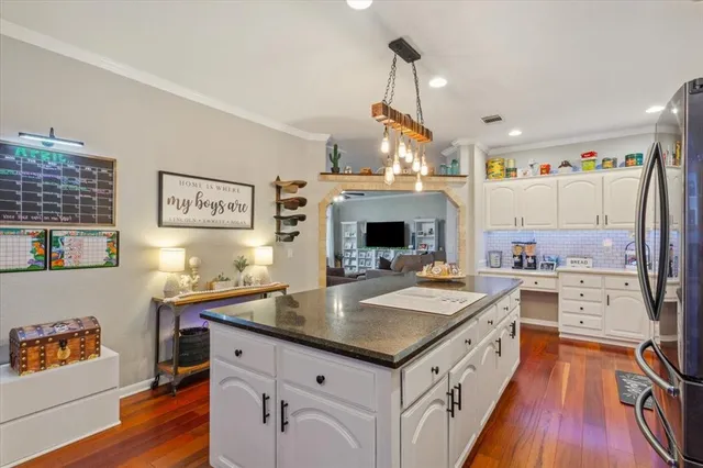 a kitchen with stainless steel appliances a stove refrigerator sink and cabinets