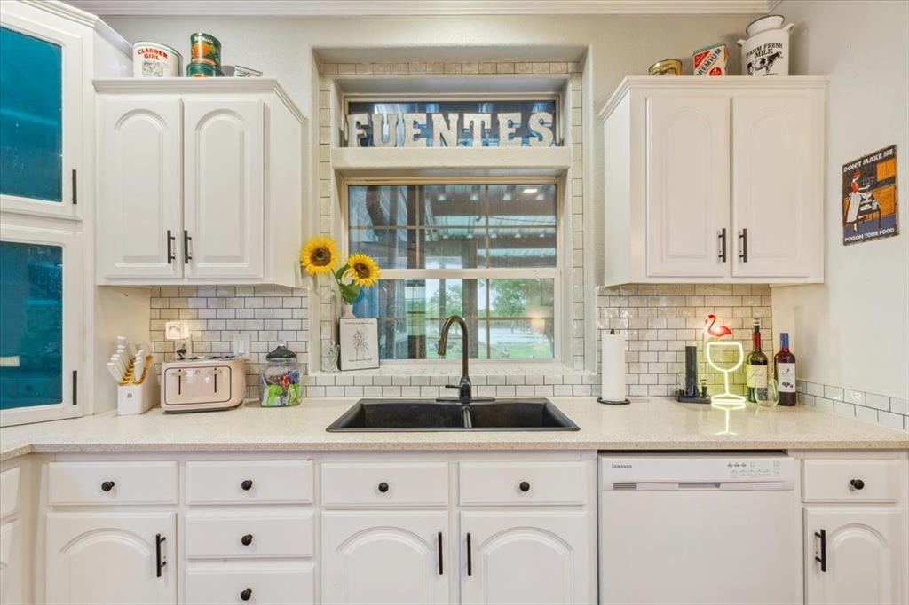 3356 Kattner Road Riesel, TX 76682 - Photo 15 of 40 a kitchen with white cabinets and clock on the wall