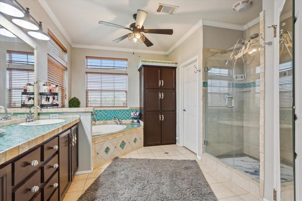 3356 Kattner Road Riesel, TX 76682 - Photo 20 of 40 a bathroom with a granite countertop sink a mirror a shower and a bathtub