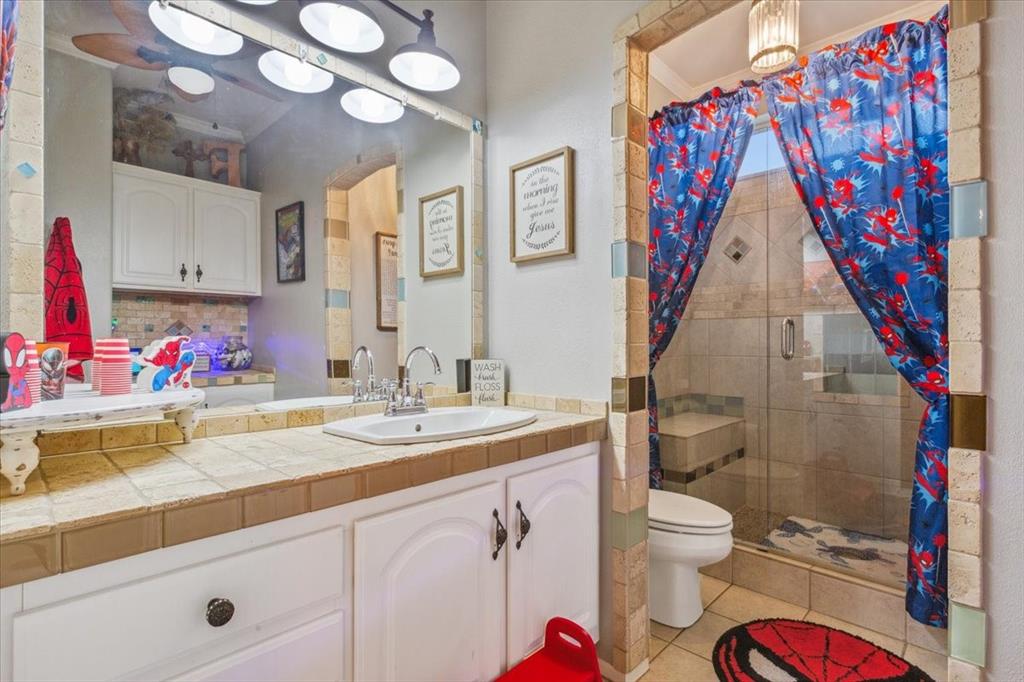 3356 Kattner Road Riesel, TX 76682 - Photo 24 of 40 a bathroom with a sink vanity mirror and toilet