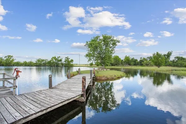 a wooden bench sitting next to a lake