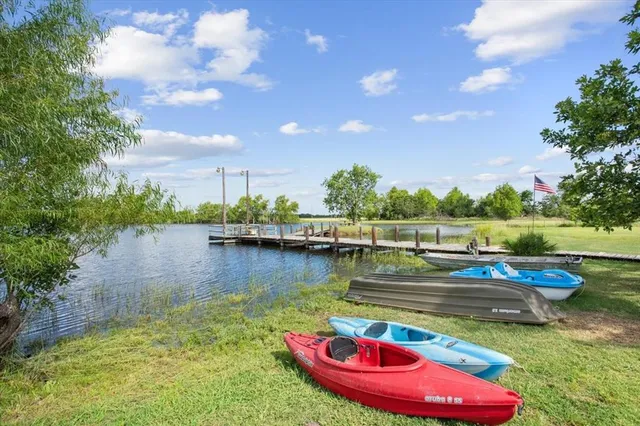 a view of a lake with couches and wooden floor