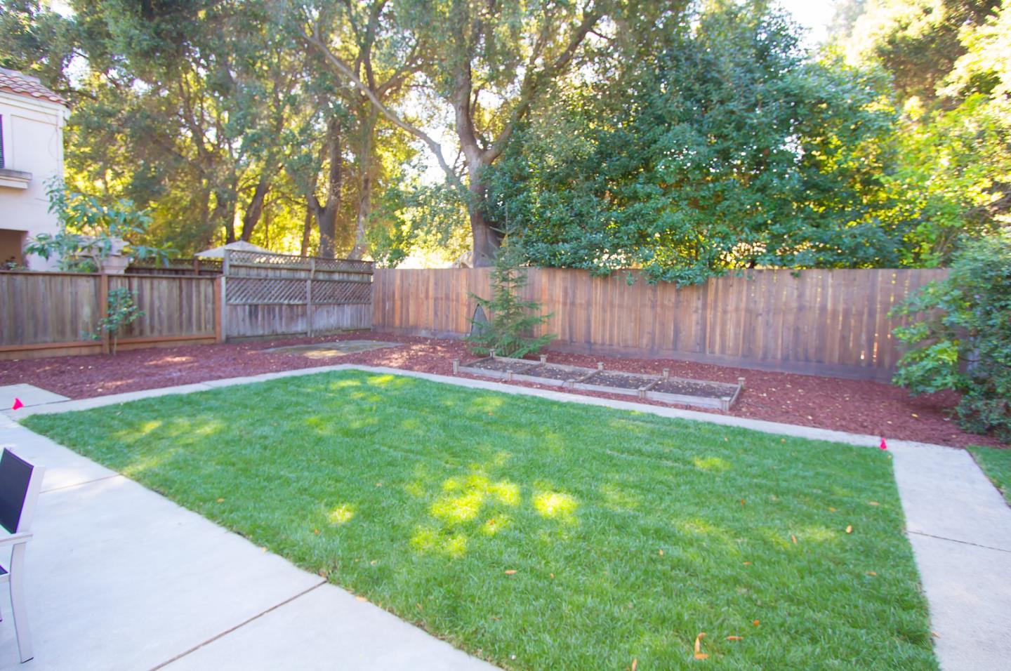 655 Gilbert Avenue Menlo Park, CA 94025 - Photo 25 of 28 a view of a backyard with a garden and wooden fence