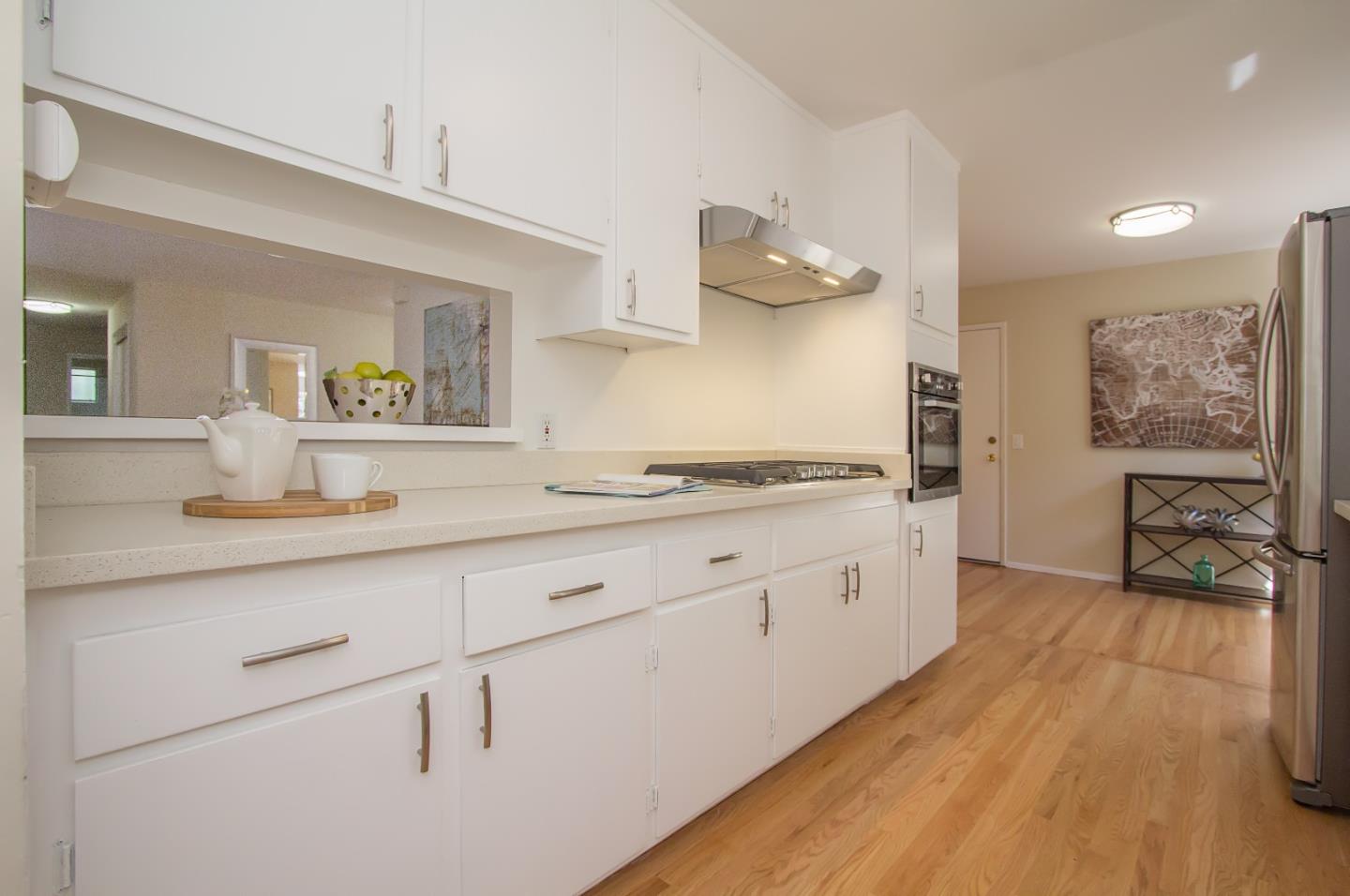 655 Gilbert Avenue Menlo Park, CA 94025 - Photo 10 of 28 a spacious bathroom with a granite countertop sink and a mirror