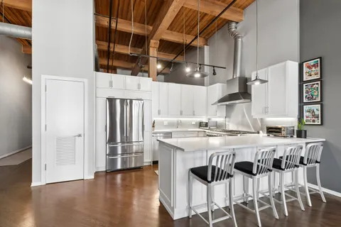 a kitchen with cabinets and wooden floor