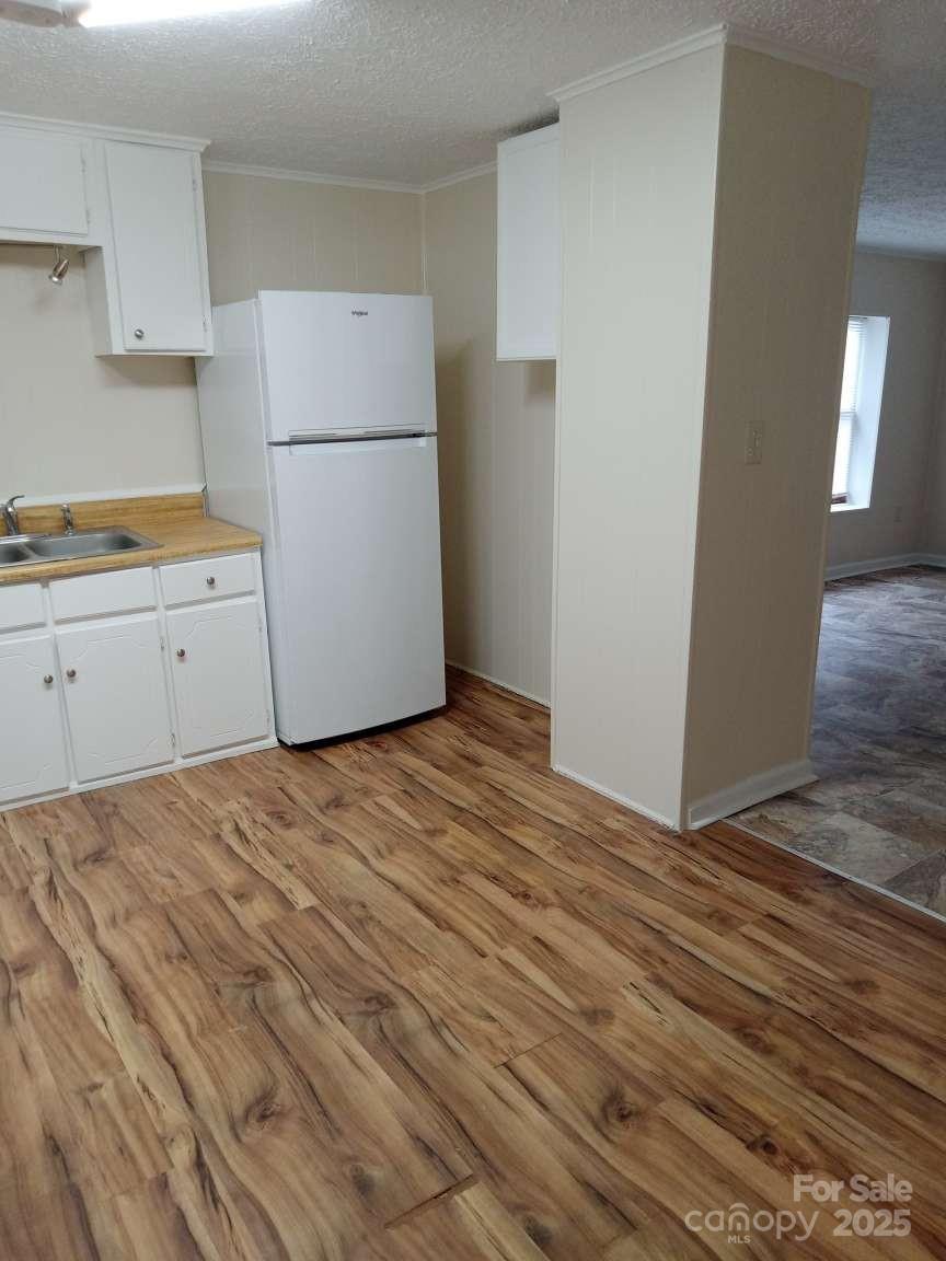 381 North Cleghorn Street Rutherfordton, NC 28139 - Photo 11 of 18 a kitchen with a refrigerator a stove top oven