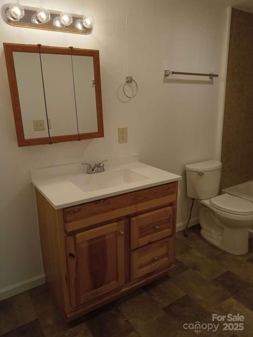 381 North Cleghorn Street Rutherfordton, NC 28139 - Photo 15 of 18 a bathroom with a sink toilet vanity and mirror