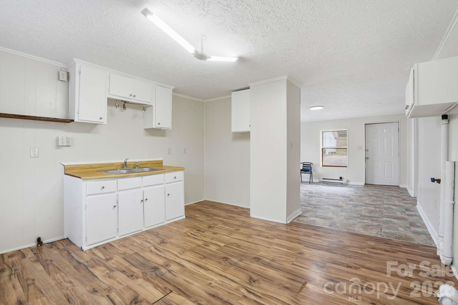 381 North Cleghorn Street Rutherfordton, NC 28139 - Photo 17 of 19 a kitchen with a sink cabinets and wooden floor