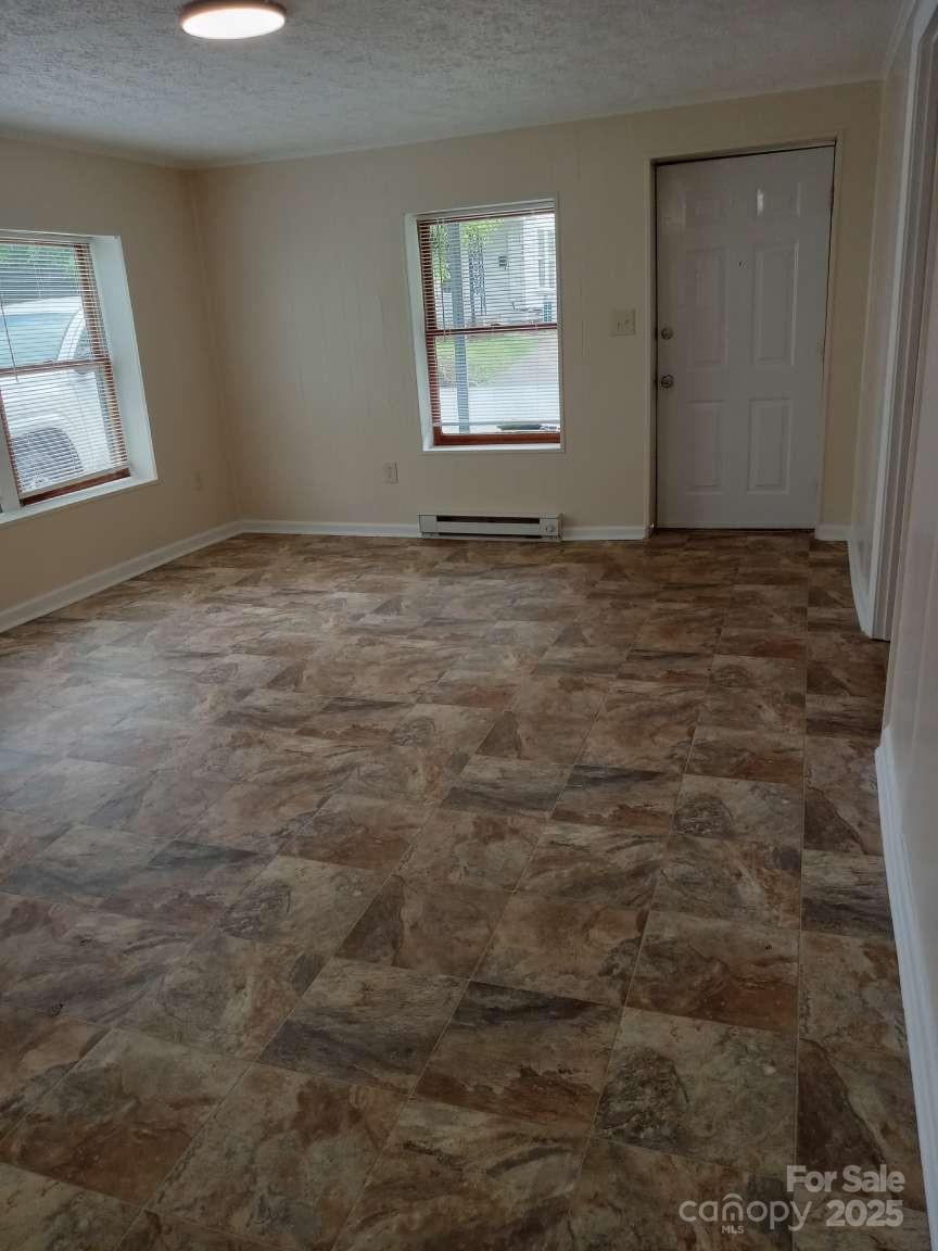 381 North Cleghorn Street Rutherfordton, NC 28139 - Photo 4 of 18 an empty room with windows