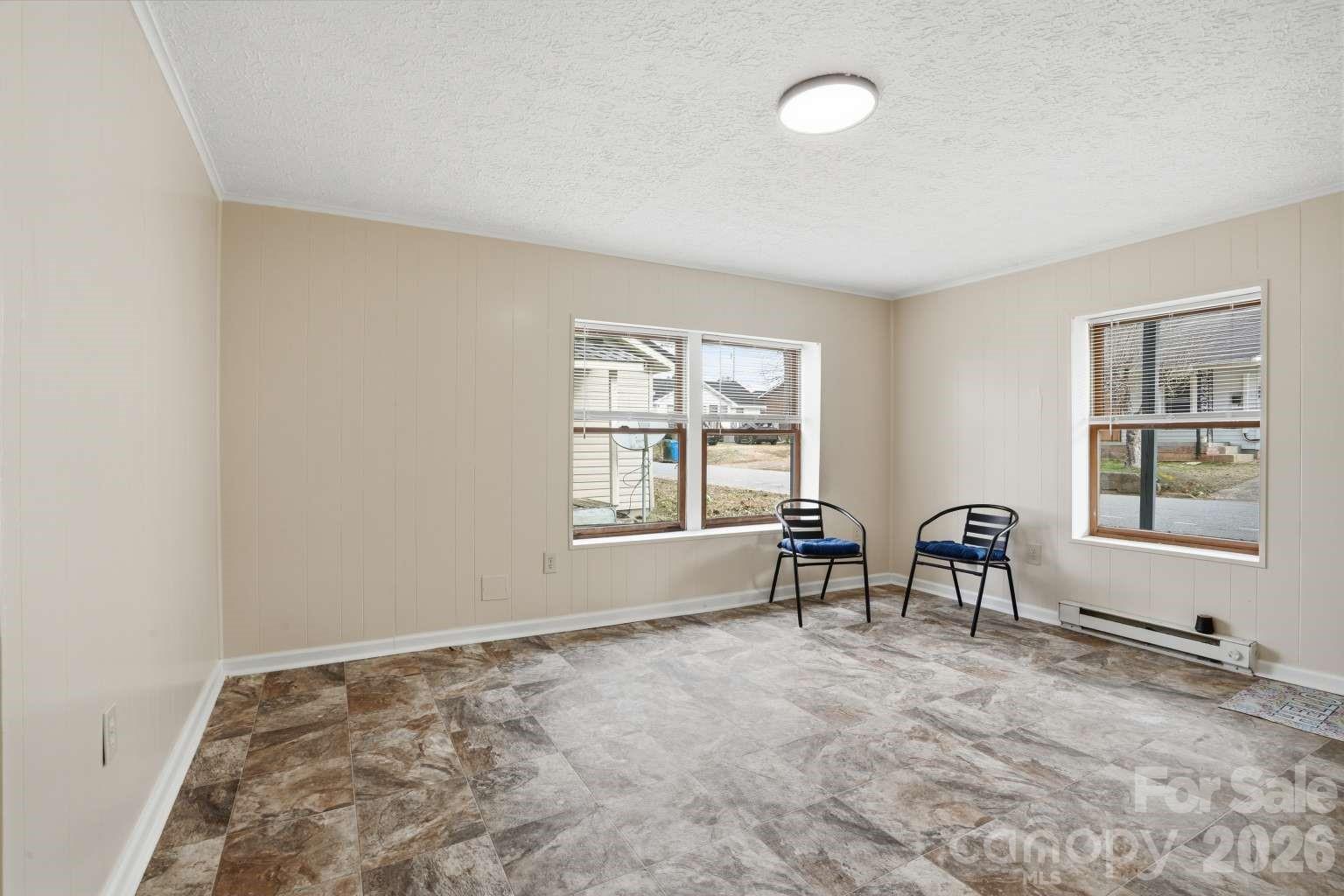 381 North Cleghorn Street Rutherfordton, NC 28139 - Photo 7 of 19 a view of an empty room with window and chair