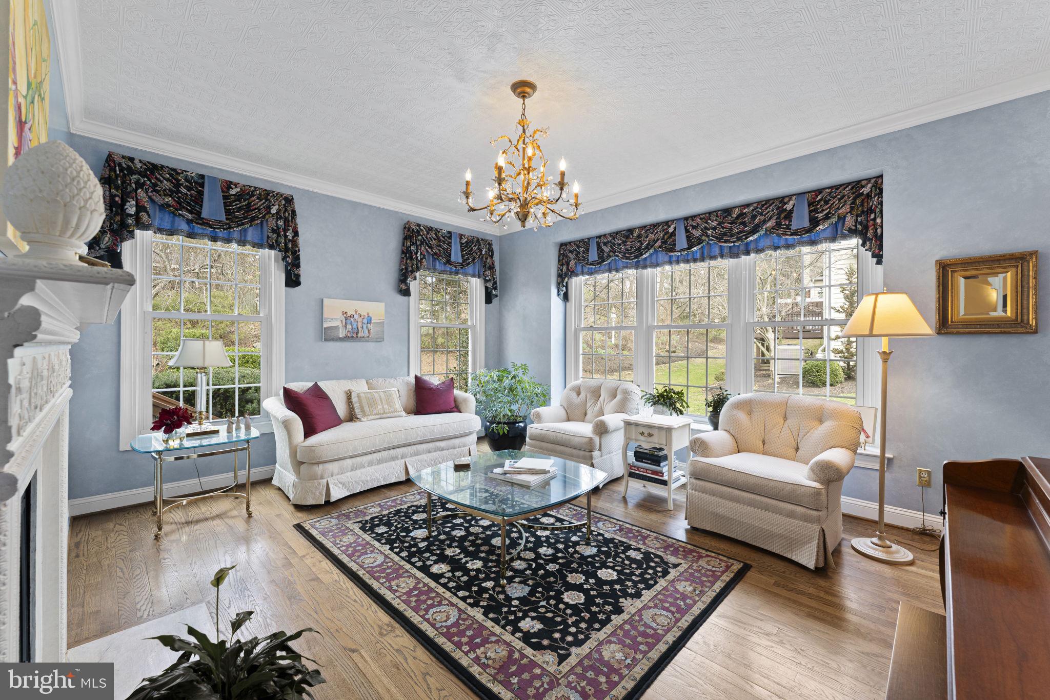 103 Carters Grove, Unit A3 Malvern, PA 19355 - Photo 14 of 41 a living room with furniture and a chandelier