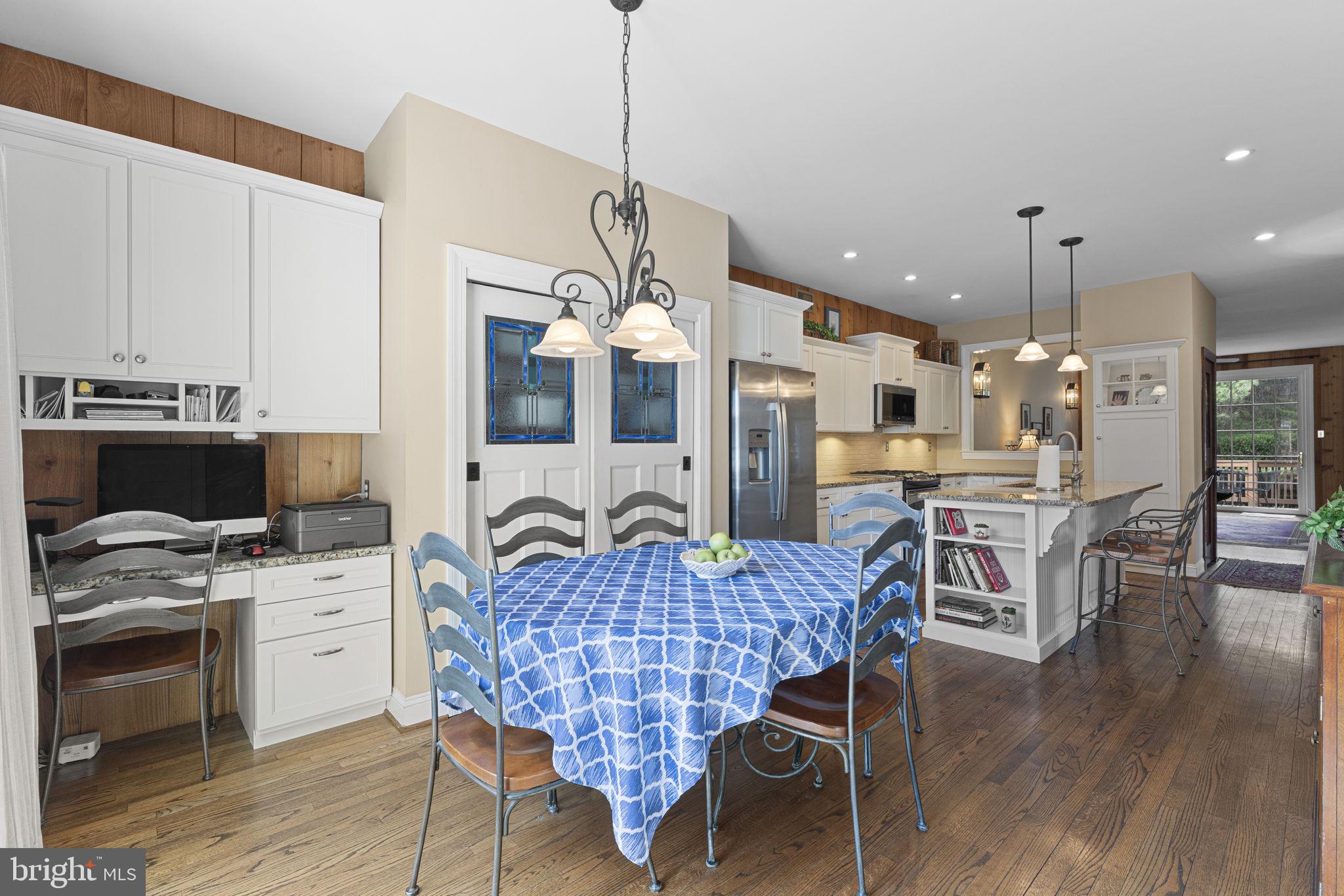 103 Carters Grove, Unit A3 Malvern, PA 19355 - Photo 24 of 41 a living room with stainless steel appliances kitchen island granite countertop furniture and wooden floor
