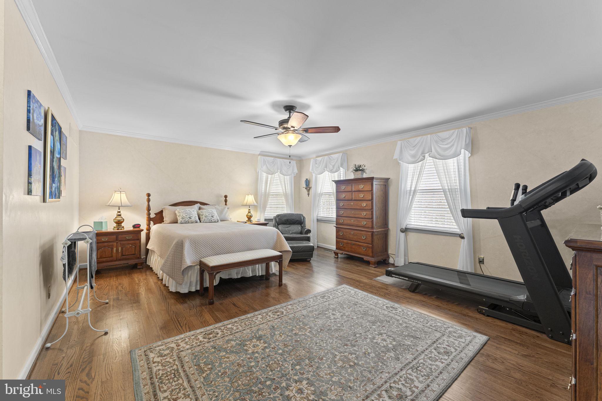 103 Carters Grove, Unit A3 Malvern, PA 19355 - Photo 27 of 41 a bedroom with a bed and wooden floor