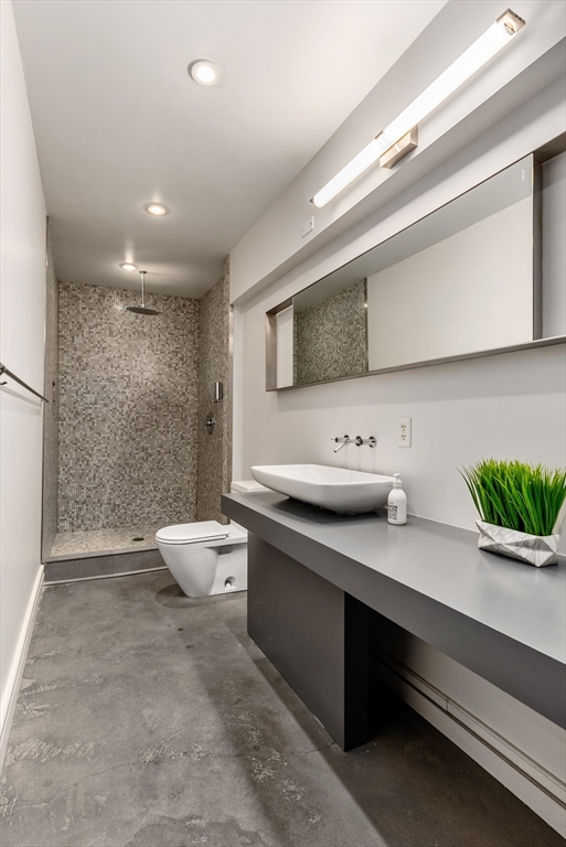 37 Bay State Road, Unit 3 Boston, MA 02215 - Photo 11 of 18 a spacious bathroom with a double vanity sink a mirror and a