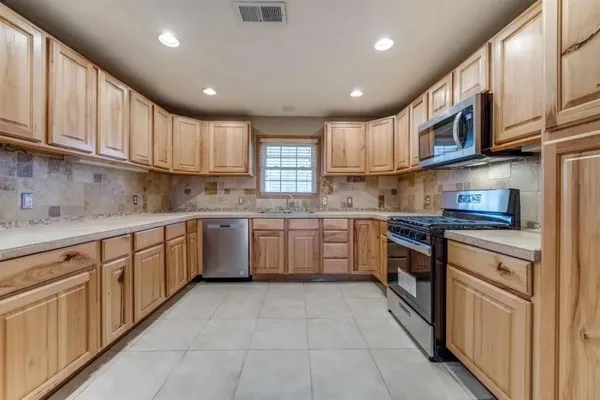 a kitchen with stainless steel appliances granite countertop a sink and cabinets