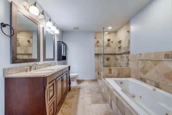 a bathroom with a tub sink and mirror