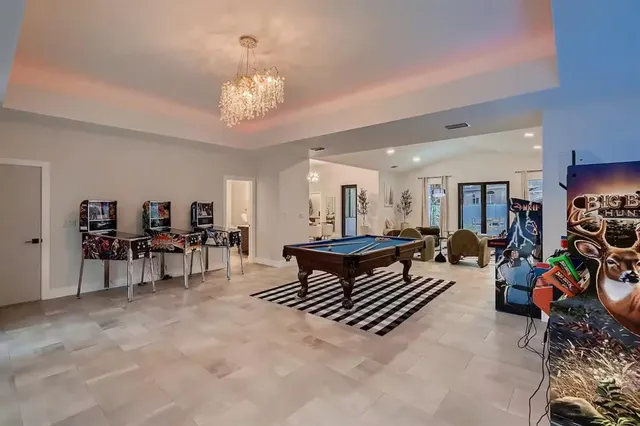 a living room with furniture and a chandelier