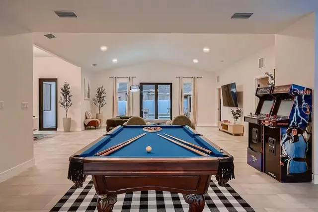 a room with furniture pool table and windows