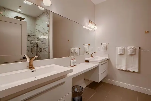 a bathroom with a sink double vanity and a mirror