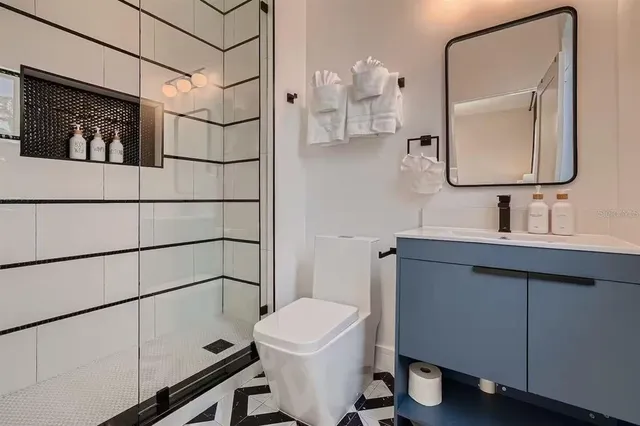 a bathroom with a toilet sink and mirror