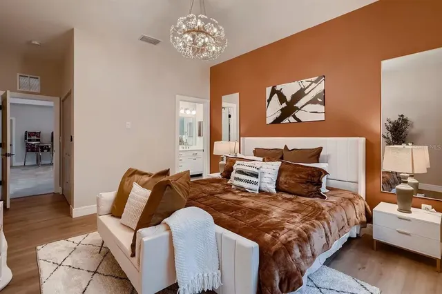 a bedroom with bed and wooden floor