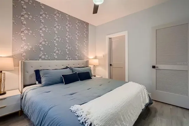 a bedroom with bed and wooden floor