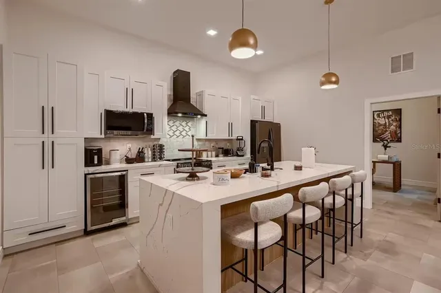 a kitchen with appliances a sink and cabinets