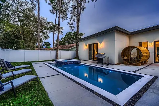 a view of a sink and chairs in the patio
