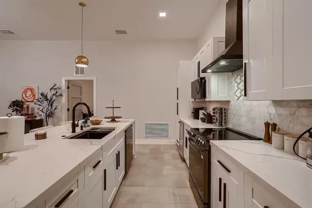 a kitchen that has a sink and a stove
