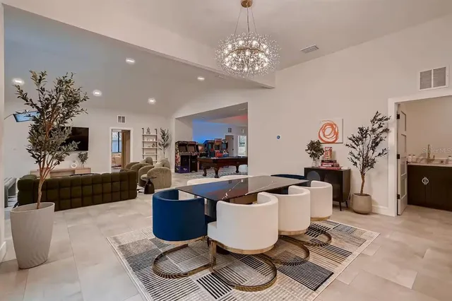 a living room with furniture a rug and a chandelier