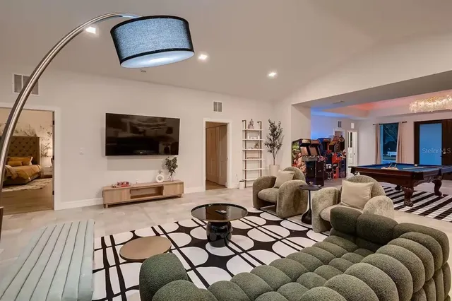 a living room with furniture fireplace and flat screen tv