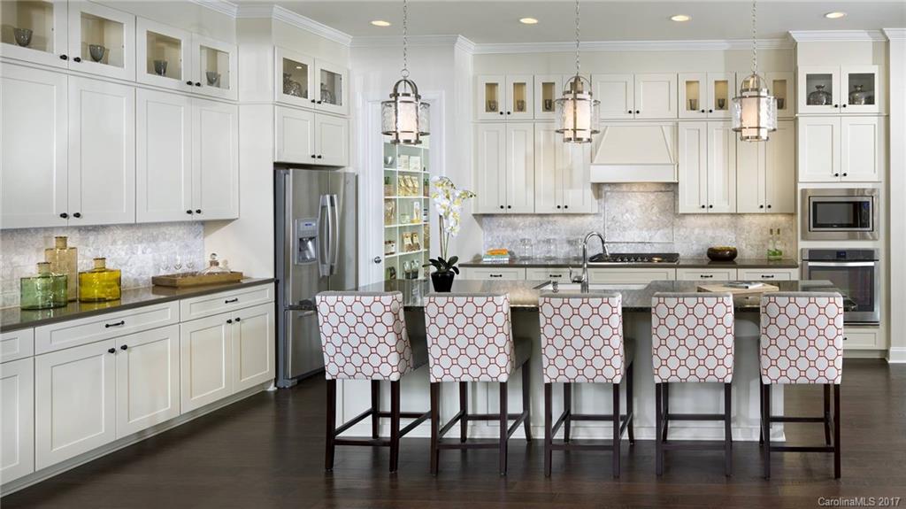 961 Emory Lane, Unit 59 Fort Mill, SC 29708 - Photo 2 of 7 a kitchen with stainless steel appliances granite countertop a white table and chairs